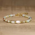 Detailed view of handmade bracelet with Baroque pearl and rainbow natural stones. - Sky Blue