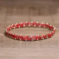 Close-up of a handcrafted red marble stone bead bracelet with gold accents. - Red Imperial Stone