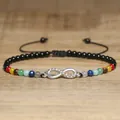 Close-up of handmade seven chakra natural stone anklet with silver infinity charm - Rainbow