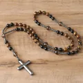 Close-up detail of natural tiger eye beads and hematite cross pendant on a rosary - Tiger Eye
