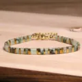 Handmade natural stone Tila bead bracelet with gold geometric spacers on rustic wood - Tila Bracelet (6)