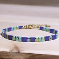 Handmade blue and turquoise Tila bead bracelet with gold spacers on light wood surface - Blue Cyan Marble Texture Style (14)