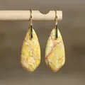 Detailed view of yellow natural imperial stone teardrop earrings with elegant gold hooks - Yellow