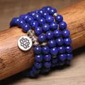 Primo piano bracciale mala 108 grani in lapislazzuli blu con ciondolo loto in argento su legno. - Lapislazzuli