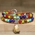 Macro detail of a bohemian wrap bracelet with multi-color chakra stones and raw pendant. - Tiger Eye Raw Stone Style (Yellow Tiger) / Triple Layer Wrap / Yellow Tiger Eye