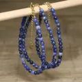 Macro view of blue natural stone beaded necklaces with gold stainless steel chains - Dark Blue