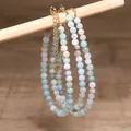 Close-up detail of handmade natural stone beaded necklace with adjustable gold chain - Light Blue