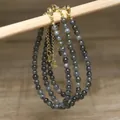 Close-up of handmade natural stone beaded necklaces with gold-tone stainless steel clasps. - Glitter Black