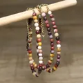 Detailed view of the colorful natural stone beads and durable gold extension chain. - Colorful