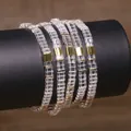 Macro view of handmade Tila bead bracelets featuring clear glass and gold square spacers - Lake Blue (TLSL-032)