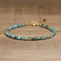 Detailed view of faceted turquoise stone beads on an adjustable gold chain bracelet - Dark Green