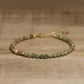 Detailed macro view of faceted African Pine natural stone beads on a gold adjustable bracelet - Grass Green