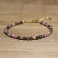 Close-up of handmade faceted natural stone beaded bracelet with adjustable clasp. - Magenta