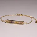 Macro view of gold-plated bracelet with amethyst and citrine beads inside pendant - Amethyst, Citrine & Rose Quartz Set