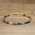 Macro detail view of handmade faceted natural stone bead bracelet with gold chain - Rainbow