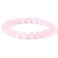 Detailed view of round 8mm rose quartz beads on an elastic stretch jewelry bracelet - 8 mm / Rose Quartz