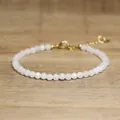 Detailed macro view of white faceted stone beads on a delicate adjustable bracelet - Off White