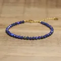 Macro detail of a faceted blue lapis lazuli gemstone beaded bracelet with gold clasp - Dark Blue
