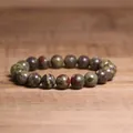 Detail view of 8mm natural Indian agate stone beaded bracelet on rustic wood surface - Dragon Blood Jasper