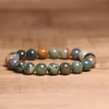 Close-up detail of 8mm natural Indian agate beaded bracelet on a rustic wood surface - Indian Agate