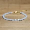 Close-up of faceted pale blue stone beaded bracelet with gold adjustable clasp - Glossy Blue