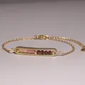 Detailed close-up of gold-plated chain bracelet with pink and dark red faceted stone beads - Pink and Brown Gradient Beads