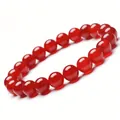 Detailed close-up of an 8mm red agate healing stone beaded stretch bracelet - 8 mm / Carnelian