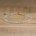 Detail of a faceted natural stone beaded bracelet with a gold adjustable clasp. - Light Green