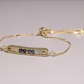 Detailed view of a gold-plated adjustable bracelet with multi-color stone beads in a bar setting - White Crystal and Lapis