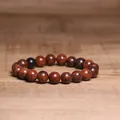 Close-up of 8mm natural mahogany obsidian beaded bracelet on wooden background. - Mahogany Obsidian