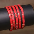 Handmade red TILA tile bead bracelet featuring golden spacers on a display roll - Red (TLSL-015)