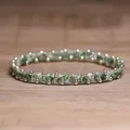 Elegant handmade green stone beaded stretch bracelet with polished gold spacers on wood - Green Spot Stone