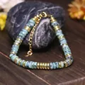 Bracciale regolabile in pietra naturale verde con perline in acciaio inox dorato - Pietra di sesamo