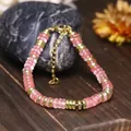 Elegante bracciale con perle abaco rosa, distanziali dorati e catena regolabile - Rosso anguria