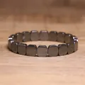 Detailed macro view of a metallic grey hematite elastic bracelet with square stone beads - Simple Square Rounded Style (#11)