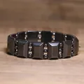 Detail view of a black hematite elastic bead bracelet on a wooden surface - Rectangle and Round Bead Alternate Style (#15)