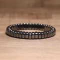 Close-up macro view of a metallic hematite beaded elastic bracelet on wood surface - Rectangle Flat Round Classic Style (#16)