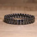 Close-up of a dark metallic hematite beaded stretch bracelet on a wooden surface. - Rectangle Block and Bead Premium Style (#18)