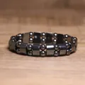 Detailed macro shot of a dark metallic hematite magnetic bead elastic bracelet - Round Bead and Column Alternate Style (#22)