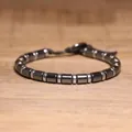 Detailed macro view of hematite cylindrical beads and silver-toned spacers on a bracelet. - Silver Metal Spacer Bead Style (#27)