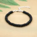 Handmade matte black saucer bead bracelet with adjustable silver lobster clasp and extender chain. - Black Plastic Beads