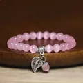 Detailed view of pink cat's eye bead bracelet with silver leaf charm pendant - Lotus root pink