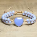 Nahaufnahme des herzförmigen Natursteins an einem blauen zweilagigen Perlenarmband - Hellblaue Streifen