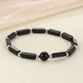 Detailed view of black stone bar and round bead energy bracelet with silver spacers - Black Stone