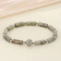 Close-up detail of natural grey stone energy bracelet with metallic spacer beads - Grey Labradorite