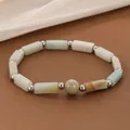 Close-up of natural stone bead bracelet with rectangular amazonite beads and silver spacers. - Amazonite