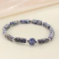 Macro detail of blue marble sodalite stone beads and silver spacers bracelet - Blue Spot Stone