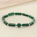 Detailed macro view of green malachite style rectangular stone beaded energy bracelet - Malachite