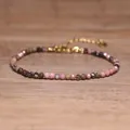 Macro detail of a handmade multi-color natural stone beaded bracelet with gold chain - Rose Tourmaline Pink Black Style (#7)