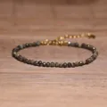Macro view of a delicate natural tourmaline bracelet with faceted beads on a wooden surface - Vintage Multicolor Mix Style (#6)